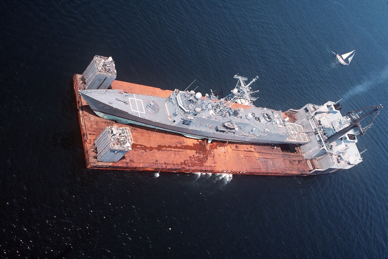 An aerial view of the guided missile frigate USS SAMUEL B. ROBERTS (FFG-58) being transported by the Dutch salvage ship MIGHTY SERVANT II.  The frigate was damaged when it struck a mine while on patrol in the Persian Gulf.